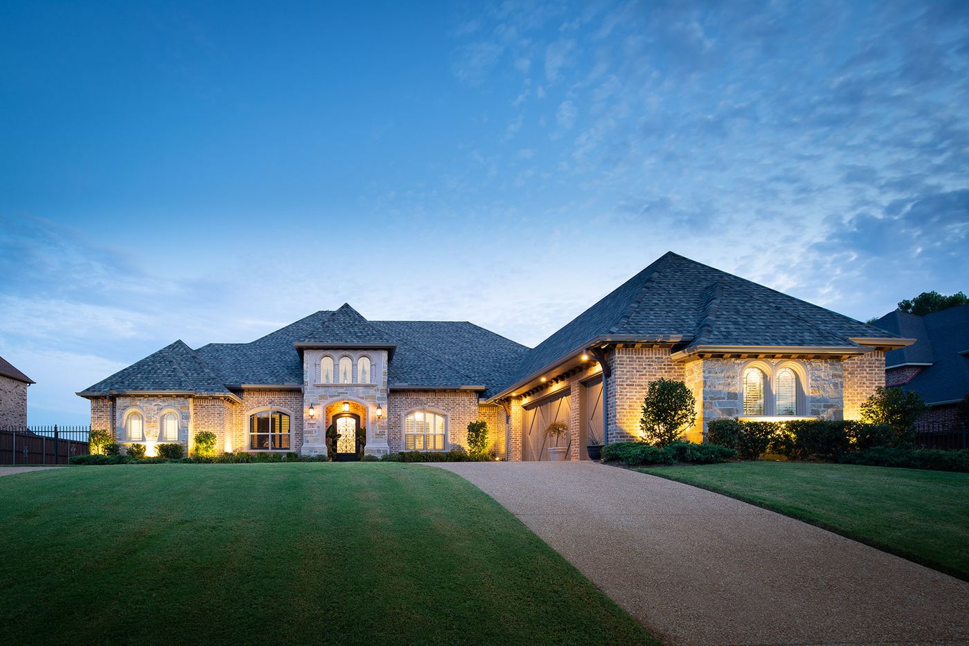 Two-story brick custom home at dusk, financed by CFS in Cedar Hill, Texas